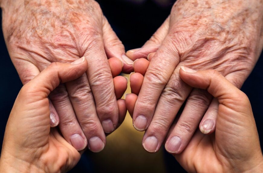 Old hands holding young ones