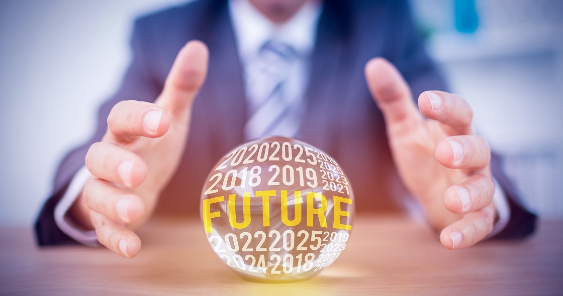 Businessman hands around a crystal ball with 'future' written on it
