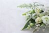 Funeral flowers laid on a plain background