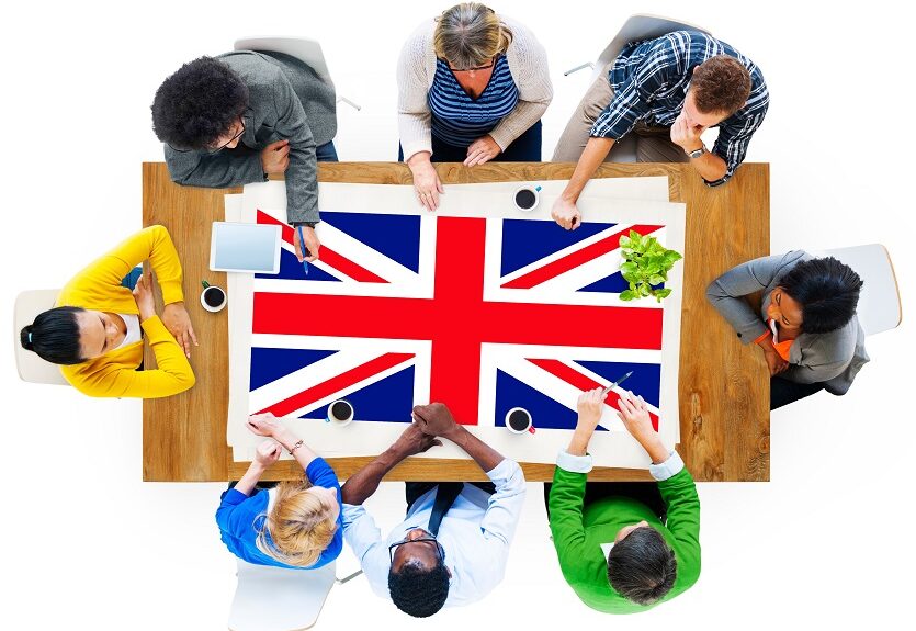 People sat around a table with a Union Flag on it